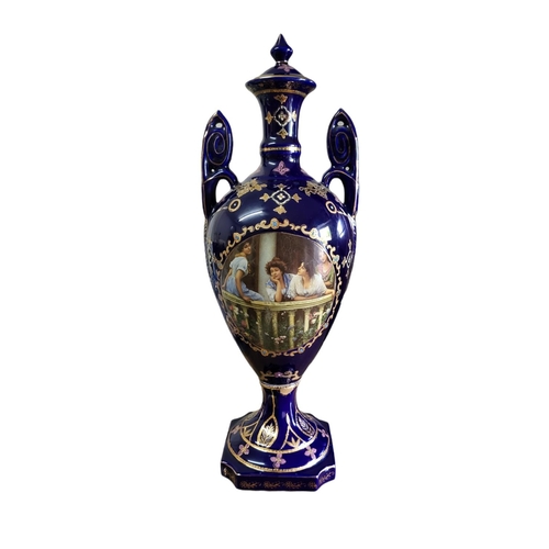 30A - A 20TH CENTURY CONTINENTAL POTTERY URN FORM VASE AND COVER
Twin handled, with transfer printed figur... 