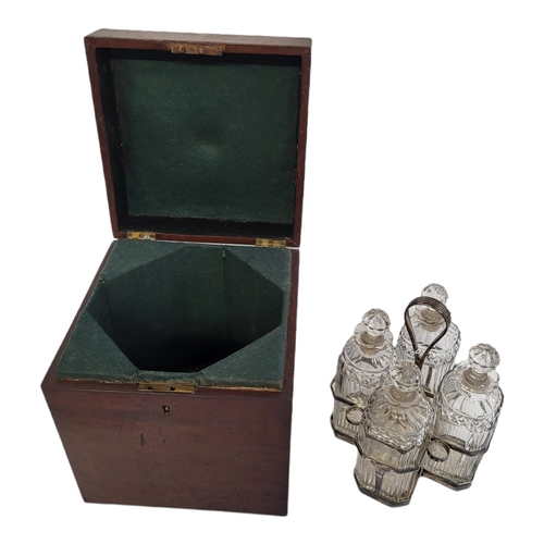 39 - A GEORGIAN SILVER AND CUT GLASS FOUR BOTTLE DECANTER SET
Having a reeded handle, on classical urn fo... 