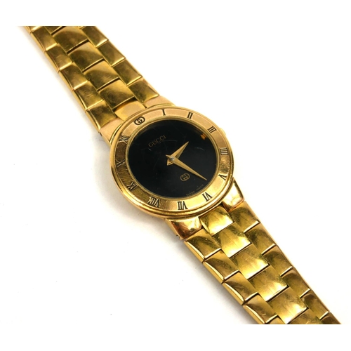 4 - GUCCI, A VINTAGE GOLD PLATED LADIES’ WRISTWATCH
The circular black dial with integral bracelet, mark... 