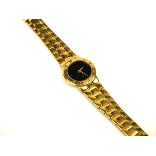 4 - GUCCI, A VINTAGE GOLD PLATED LADIES’ WRISTWATCH
The circular black dial with integral bracelet, mark... 