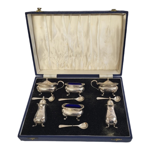 45 - A MID 20TH CENTURY SILVER AND BLUE GLASS CRUET SIX PIECE SET
Comprising two salts, two mustard pots ... 