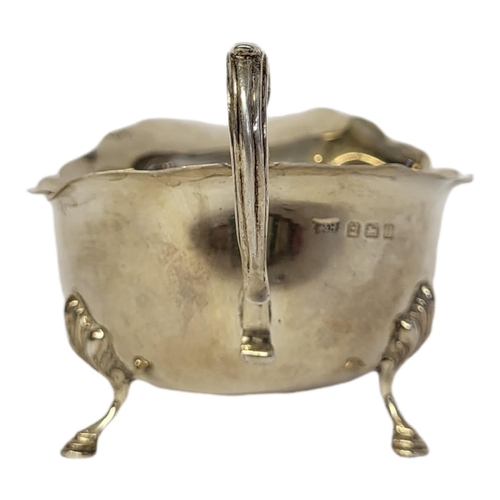 52 - WALKER AND HALL, A 20TH CENTURY GEORGIAN STYLE SILVER SAUCE BOAT
On three feet, hallmarked W&H, Birm... 