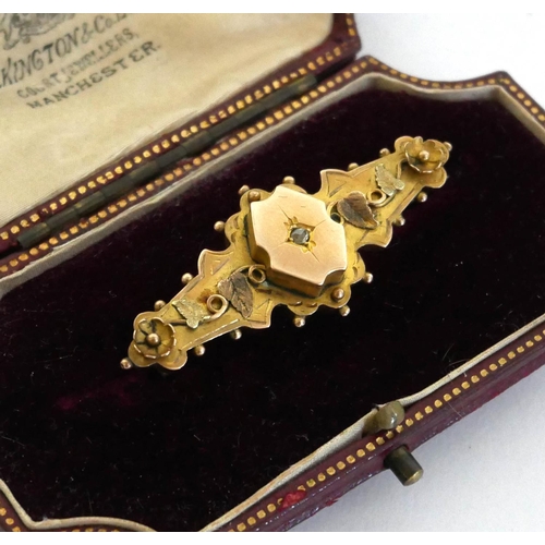 78a - A 19TH CENTURY 9CT YELLOW GOLD BROOCH IN ORIGINAL BOX
With a solitaire central diamond, leaves and f... 