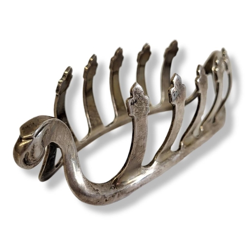 23 - AN EARLY 20TH CENTURY SILVER 'VIKING SHIP' TOASTRACK
Having scrolled ends and cruciform dividers, ha... 