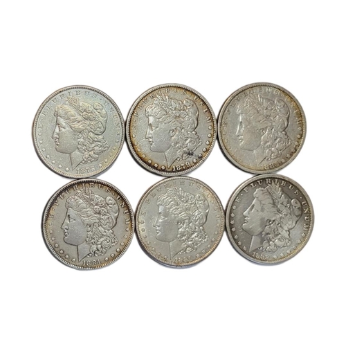 32a - A COLLECTION OF SIX AMERICAN SILVER MORGAN DOLLARS, DATED 1889, 1883, 1890, 1879, 1878 AND 1881 
Wit... 