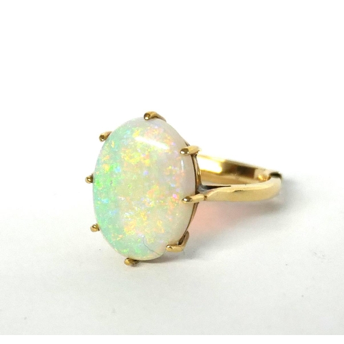 45a - A VINTAGE 9CT GOLD AND OPAL RING 
The oval cabochon cut stone on plain gold.
(opal approx 1.5cm x 1c... 