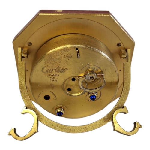 46 - CARTIER, MUST DE CARTIER, A VINTAGE GILT METAL AND ENAMEL TRAVEL CLOCK
Octagonal form with red ename... 