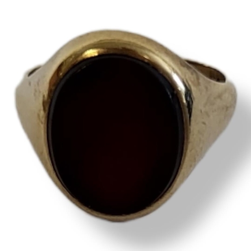 9 - An EARLY 20TH CENTURY 9CT GOLD AND HARDSTONE RING
An oval cut stone in a plain gold mount.
(size R)
... 