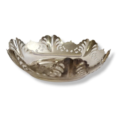 24 - AN EARLY 20TH CENTURY SILVER SWEETMEAT DISH
Having a scrolled edge with pierced design, hallmarked S... 