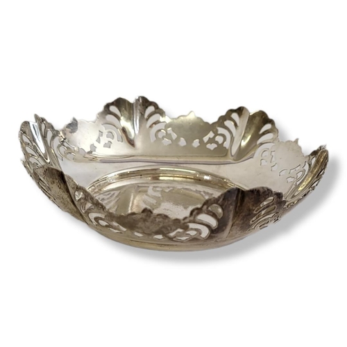 24 - AN EARLY 20TH CENTURY SILVER SWEETMEAT DISH
Having a scrolled edge with pierced design, hallmarked S... 