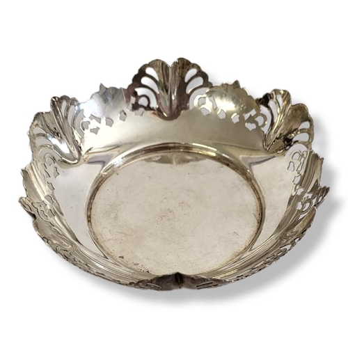 24 - AN EARLY 20TH CENTURY SILVER SWEETMEAT DISH
Having a scrolled edge with pierced design, hallmarked S... 