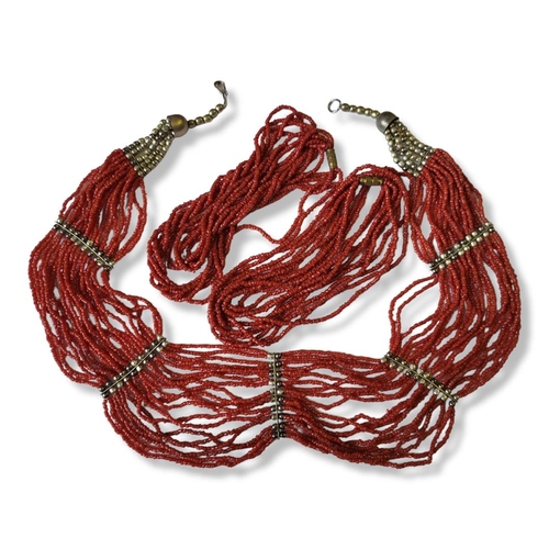 25a - A COLLECTION OF THREE VINTAGE CONTINENTAL WHITE METAL AND RED CORAL NECKLACES
To include a multi str... 