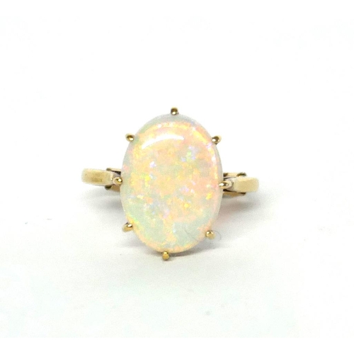 45a - A VINTAGE 9CT GOLD AND OPAL RING 
The oval cabochon cut stone on plain gold.
(opal approx 1.5cm x 1c... 