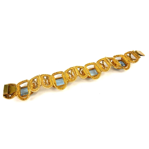 206 - A VINTAGE CONTINENTAL  SILVER GILT FILIGREE AND  PASTE  BRACELET
Having four baguette cut pale blue ... 