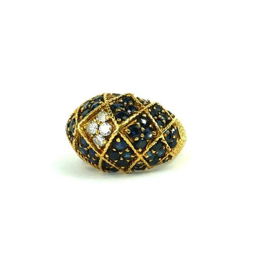 213 - A VINTAGE YELLOW METAL, DIAMOND AND SAPPHIRE BOMBE RING
Having an arrangement of round cut diamonds ... 