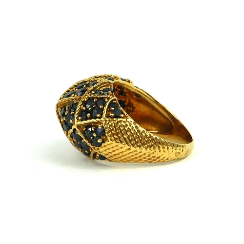 213 - A VINTAGE YELLOW METAL, DIAMOND AND SAPPHIRE BOMBE RING
Having an arrangement of round cut diamonds ... 