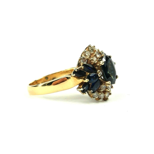 214 - A VINTAGE 14CT GOLD, DIAMOND AND SAPPHIRE CLUSTER RING
The oval cut central sapphire edged with roun... 