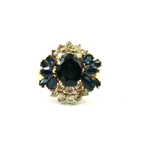 214 - A VINTAGE 14CT GOLD, DIAMOND AND SAPPHIRE CLUSTER RING
The oval cut central sapphire edged with roun... 