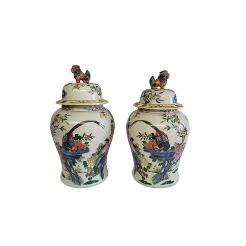 369A - A PAIR OF CHINESE VASES VASES AND COVERS
With kylin finials and enamelled decoration in the form of ... 