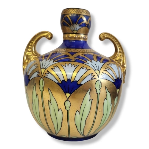 381 - PICKARD, AN AMERICAN ART DECO PORCELAIN VASE
Twin scrolled handles and decorated with a geometric fa... 