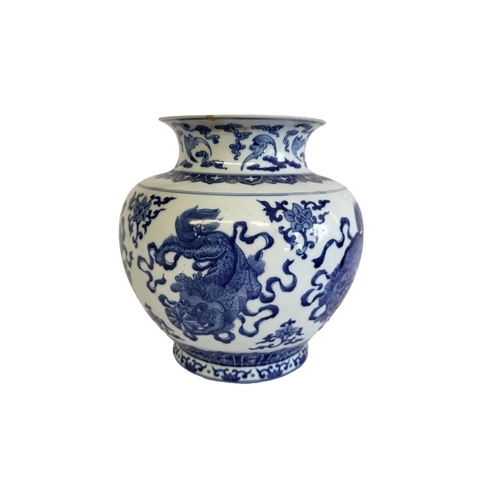 359 - A CHINESE BLUE AND WHITE VASE
The flared neck on a bulbous body, decorated with dragons and foliage,... 