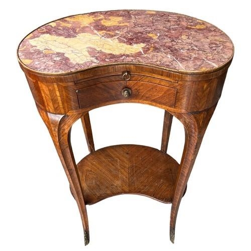 561 - AN 18TH CENTURY FRENCH KIDNEY SHAPED SIDE TABLE
The rouge inset top above slide and drawers, on cabr... 