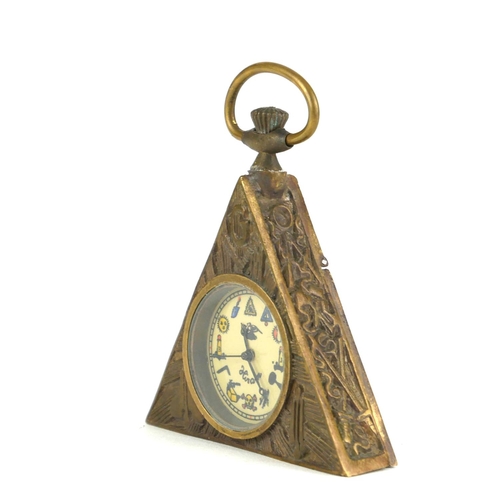 183 - A NOVELTY BRASS MASONIC POCKET WATCH
Triangular form with bossed symbols to case and mechanical move... 