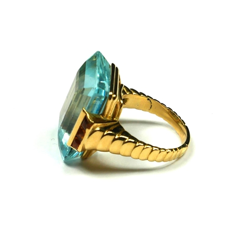 228 - A VINTAGE YELLOW METAL, AQUAMARINE AND CITRINE RING
The large step cut aquamarine flanked by two row... 