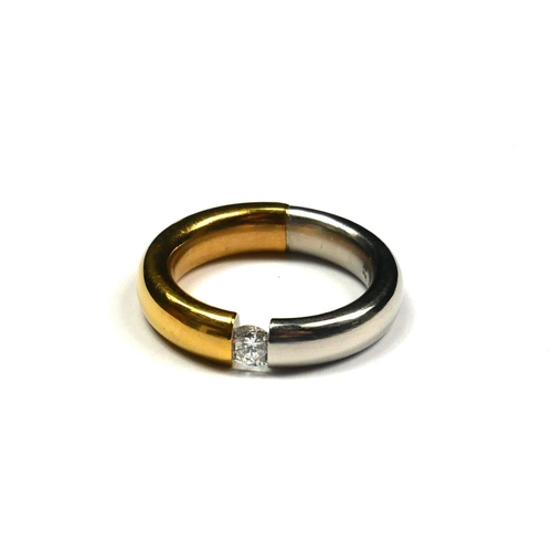 252 - NIESSING, AN 18CT BICOLOUR GOLD AND DIAMOND SOLITAIRE RING
The single round cut diamond in a tension... 