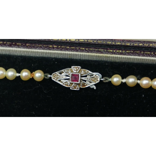 260 - A VINTAGE 9CT WHITE GOLD, DIAMOND AND GARNET PEARL NECKLACE
The strand of graduated cultured pearls ... 