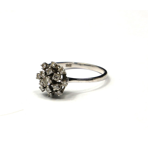 263 - A VINTAGE 18CT WHITE GOLD AND DIAMOND CLUSTER RING
Having an arrangement of round cut diamonds formi... 