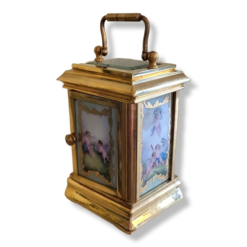 310 - A GILT BRASS AND BEVELED GLASS CARRIAGE CLOCK 
With porcelain multi dial face and three hand painted... 