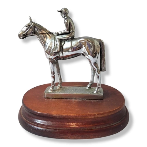 317 - AN ART DECO CHROME RACEHORSE AND JOCKEY
Standing pose on a carved wooden base.
(approx 12cm)