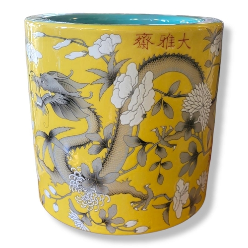 373A - A LARGE CHINESE BRUSH POT
Decorated with dragon amongst foliage on a yellow ground, bearing a four c... 