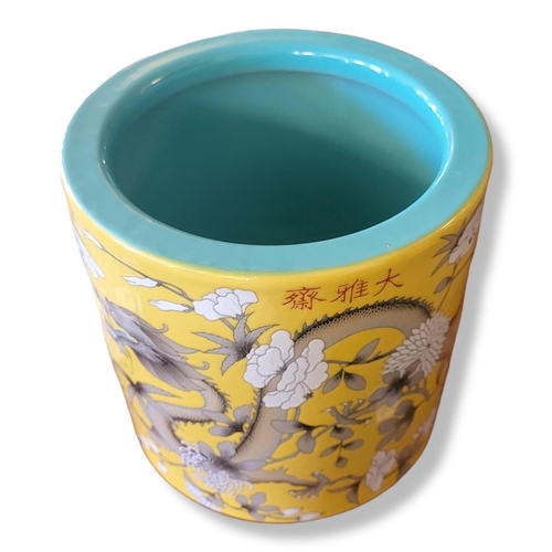 373A - A LARGE CHINESE BRUSH POT
Decorated with dragon amongst foliage on a yellow ground, bearing a four c... 