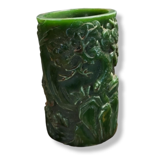 400 - A 20TH CENTURY GREEN GLAZED CHINESE JADE CYLINDRICAL BRUSH POT
Carved with immortals and pagodas in ... 