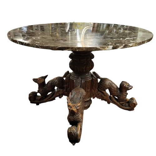 513 - A LATE 19TH CENTURY CARVED BLACK FOREST OAK TABLE
With later circular brown marble top, the acanthus... 