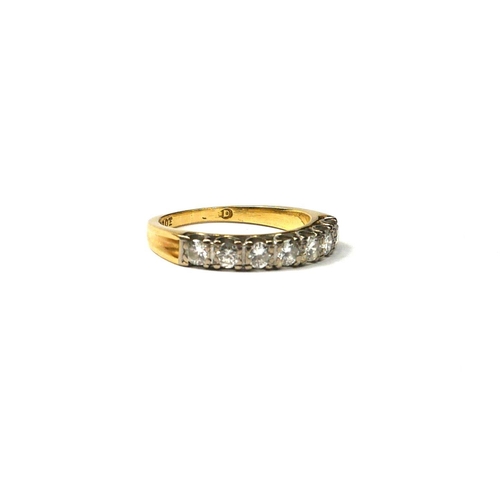 203A - AN 18CT GOLD AND DIAMOND RING
Set with seven round cut diamonds flanked by indented finish shoulders... 