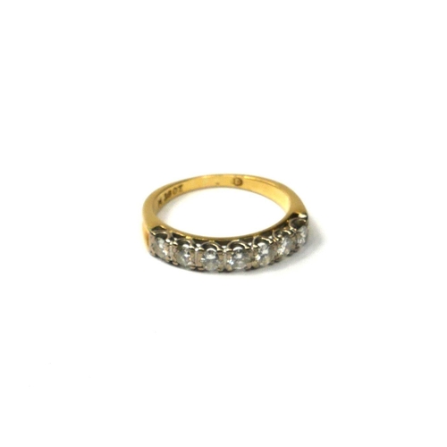 203A - AN 18CT GOLD AND DIAMOND RING
Set with seven round cut diamonds flanked by indented finish shoulders... 