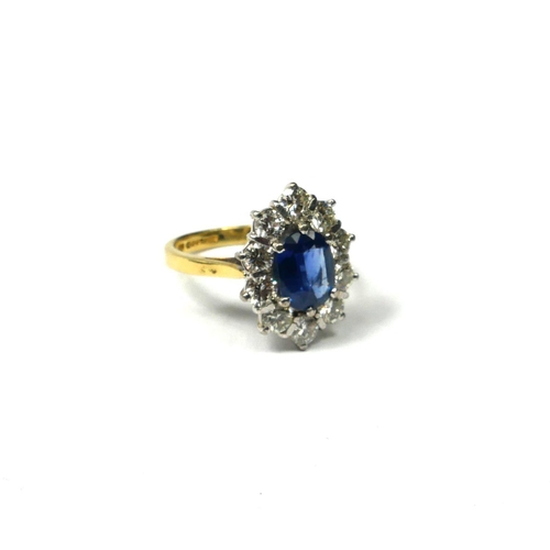 204A - AN 18CT YELLOW AND WHITE GOLD, SAPPHIRE AND DIAMOND RING
The central oval cut sapphire surrounded by... 