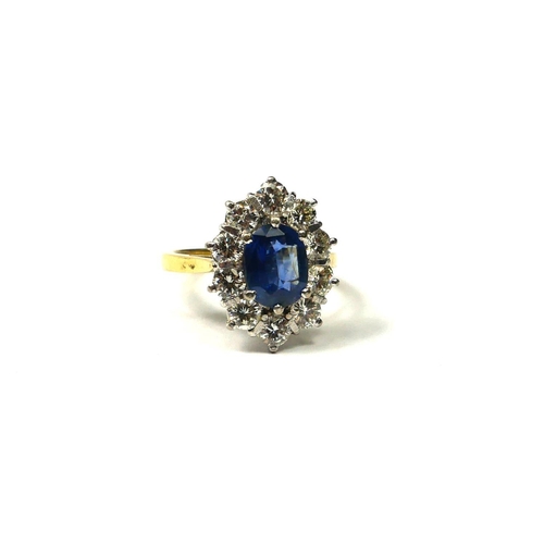 204A - AN 18CT YELLOW AND WHITE GOLD, SAPPHIRE AND DIAMOND RING
The central oval cut sapphire surrounded by... 