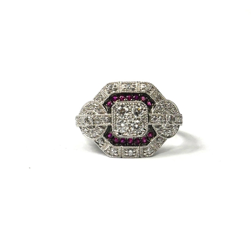 208A - AN ART DECO STYLE 18CT WHITE GOLD, RUBY AND DIAMOND CLUSTER RING
Having four central diamonds and tw... 