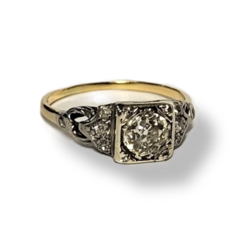 213A - AN EARLY 20TH CENTURY YELLOW METAL AND DIAMOND SOLITAIRE RING 
Round cut stone with diamonds set to ... 