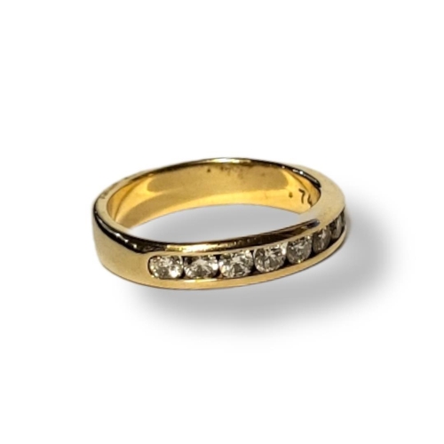 214A - AN 18CT GOLD AND DIAMOND ETERNITY RING 
The single row of round cut diamonds in a channel setting.
(... 