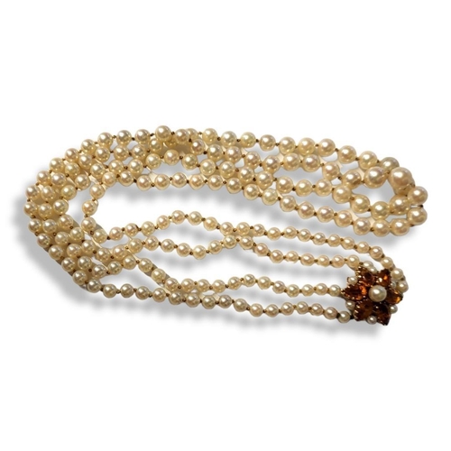 222A - A VINTAGE 9CT GOLD AND GEM SET PEARL NECKLACE The cluster of trillion cut orange stones with two sta... 