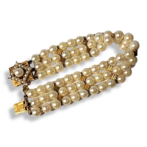 232A - A CONTINENTAL YELLOW METAL AND PEARL BRACELET
Three rows of cultured pearls with square clasp set wi... 