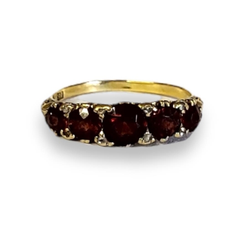 193A - AN EARLY 20TH CENTURY 18CT GOLD GARNET AND DIAMOND RING
Five graduated round cut garnets intersperse... 