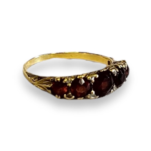 193A - AN EARLY 20TH CENTURY 18CT GOLD GARNET AND DIAMOND RING
Five graduated round cut garnets intersperse... 