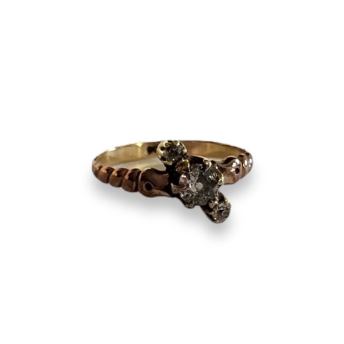 198A - A LATE 19TH/EARLY 20TH CENTURY 9CT GOLD AND DIAMOND THREE STONE RING
Having a row of graduated round... 