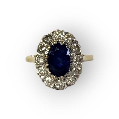 195A - AN 18CT GOLD, SAPPHIRE AND DIAMOND CLUSTER RING
The central oval cut sapphire edged with round cut d... 